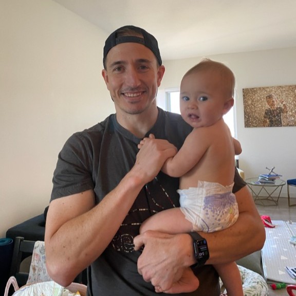 Brian's son holding his baby