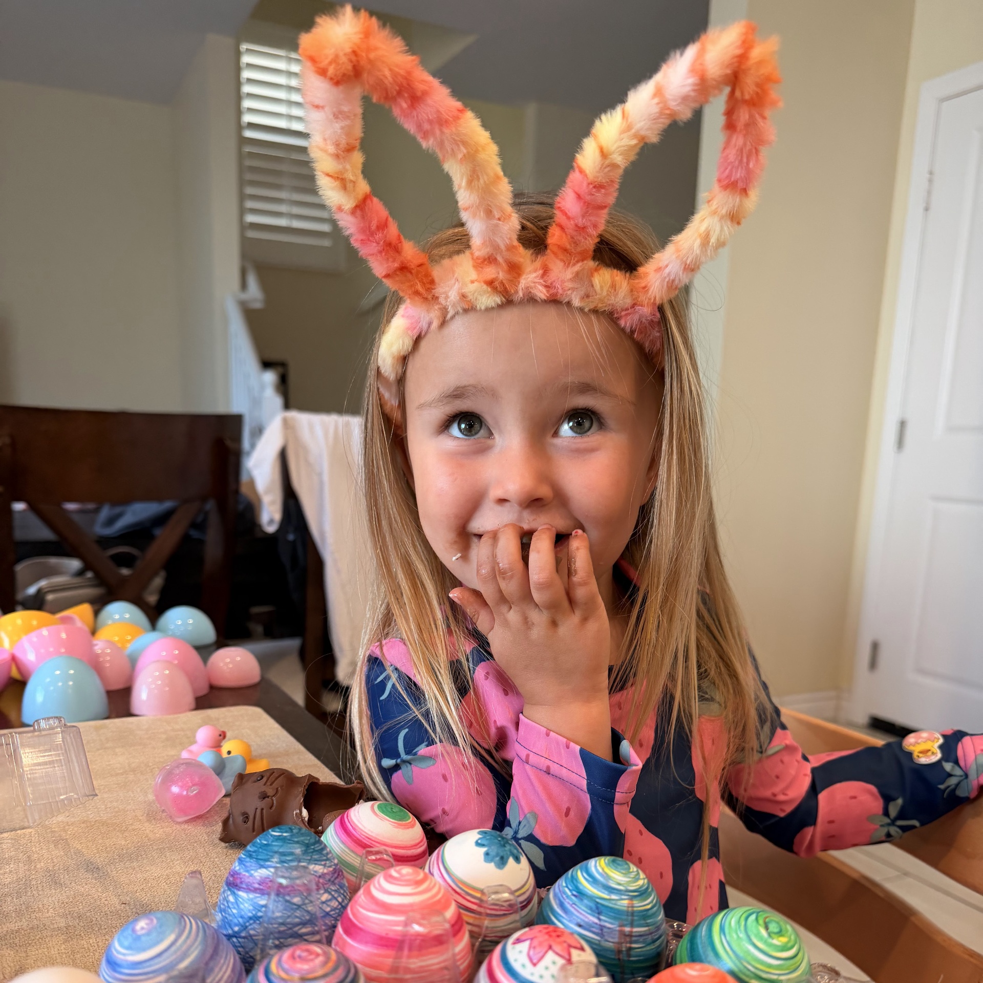 Brian's granddaughter with Easter eggs and bunny ears