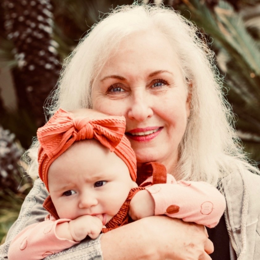 Brian's wife holding their granddaughter